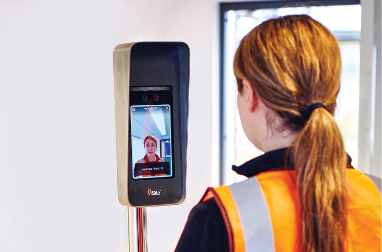 a women signing in on site with a face mini