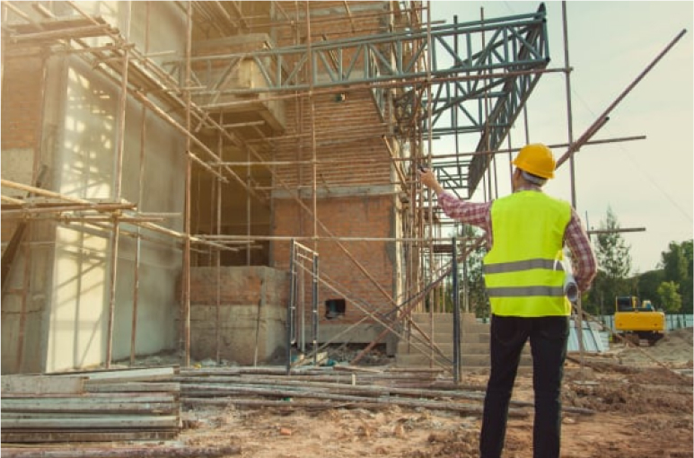 construction worker on site looking at building