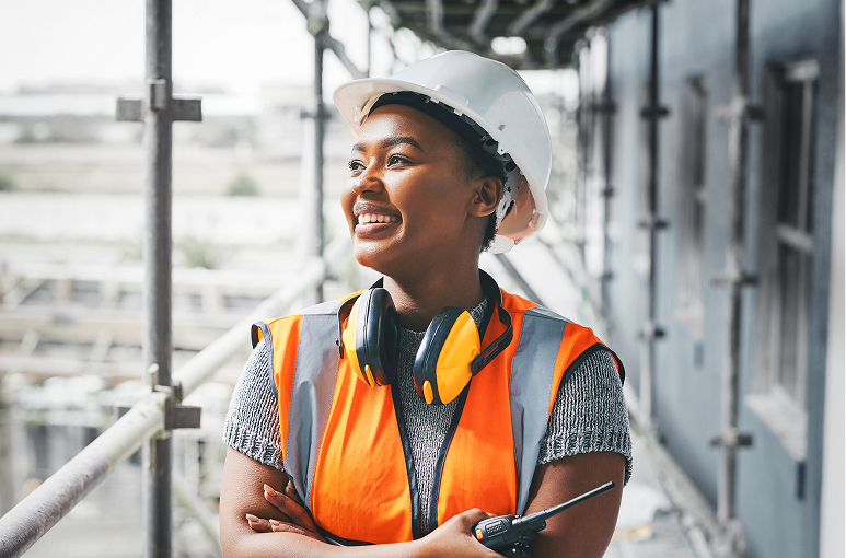 project manager on a construction site walking with a walkie talkie