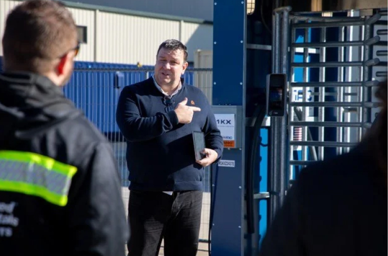 Nick Wilkinson in America at psg talking to construction workers outside of a pod