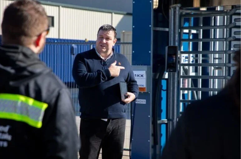 Nick Wilkinson in America at psg talking to construction workers outside of a pod